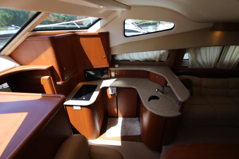 Slide: The Image of Luxurious interior of 2006 Silverton 38 Sport Bridge yacht with modern kitchen amenities. - 11