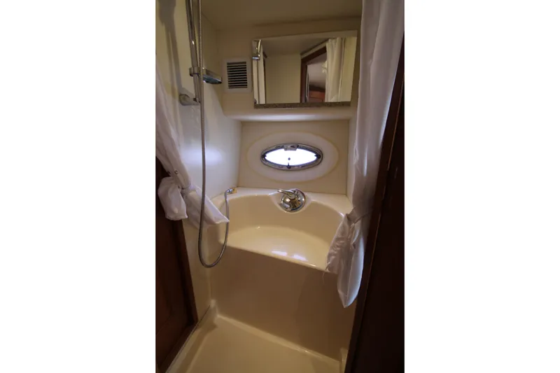 Slide: The Image of Compact bathroom with shower in 2006 Silverton 38 Sport Bridge yacht. - 22