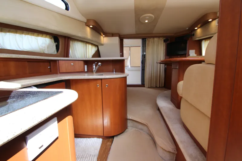 Slide: The Image of Interior of 2006 Silverton 38 Sport Bridge yacht with modern kitchen and seating area. - 23
