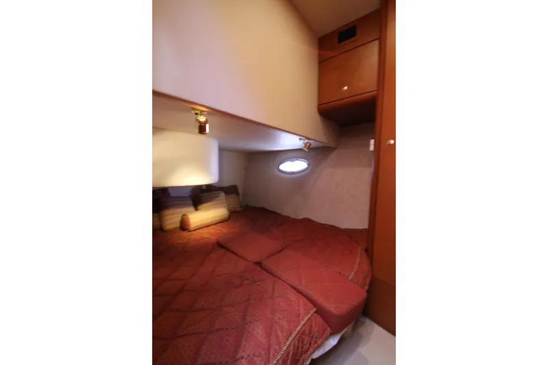 Slide: The Image of Interior cabin of 2006 Silverton 38 Sport Bridge with cozy bed and porthole window. - 26
