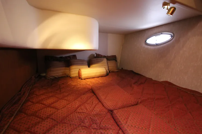 Slide: The Image of Cozy cabin interior of 2006 Silverton 38 Sport Bridge with plush bedding and soft lighting. - 27