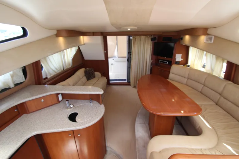 Slide: The Image of Luxurious interior of 2006 Silverton 38 Sport Bridge yacht with elegant seating and kitchenette. - 28