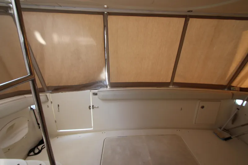 Slide: The Image of Interior view of a 2006 Silverton 38 Sport Bridge boat with beige canopy. - 29