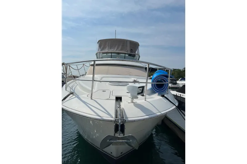 Slide: The Image of 2006 Silverton 38 Sport Bridge yacht docked at marina, front view. - 3