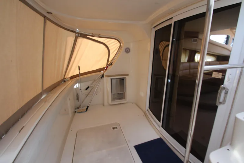 Slide: The Image of 2006 Silverton 38 Sport Bridge interior with sliding glass doors and beige seating area. - 30