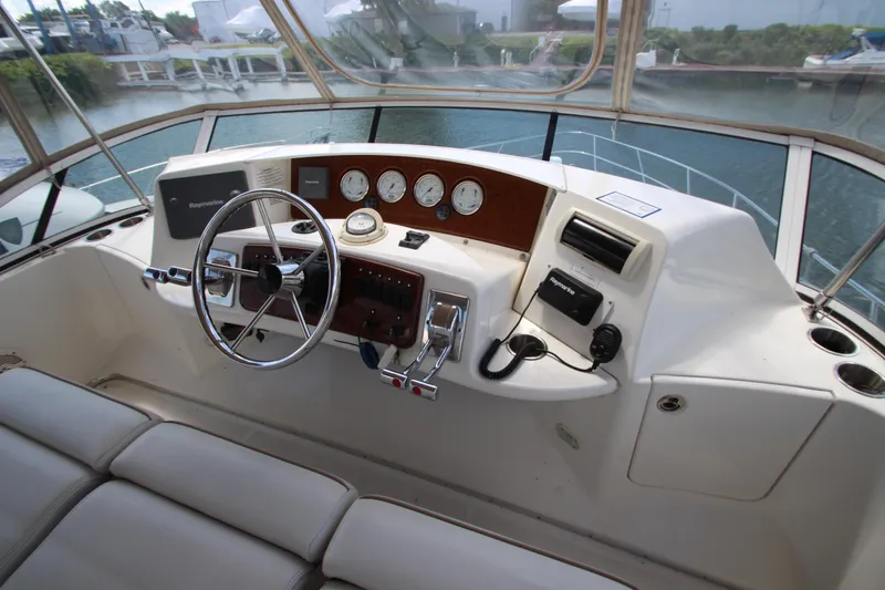 Slide: The Image of Helm of 2006 Silverton 38 Sport Bridge with steering wheel and navigation instruments. - 34