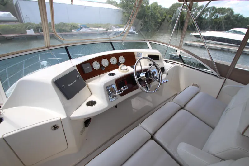 Slide: The Image of 2006 Silverton 38 Sport Bridge helm with steering wheel and navigation instruments. - 36