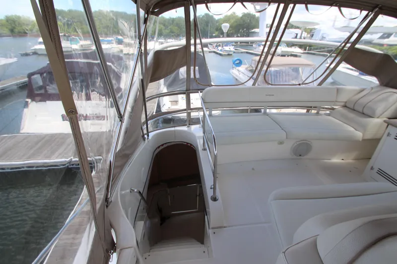 Slide: The Image of 2006 Silverton 38 Sport Bridge interior with spacious seating and marina view. - 39