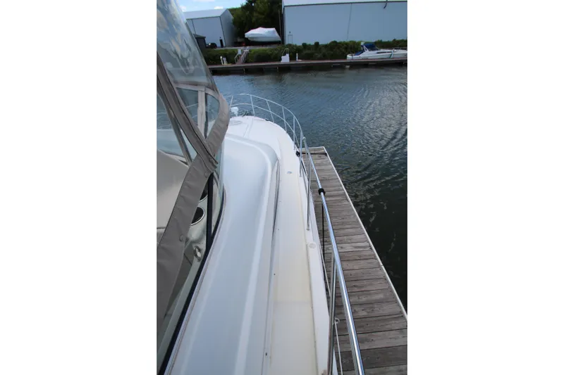 Slide: The Image of 2006 Silverton 38 Sport Bridge yacht docked at marina, side view. - 42