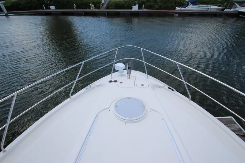 Slide: The Image of Bow view of 2006 Silverton 38 Sport Bridge at a marina dock. - 44