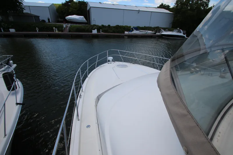 Slide: The Image of 2006 Silverton 38 Sport Bridge yacht docked at marina, view from bow. - 47