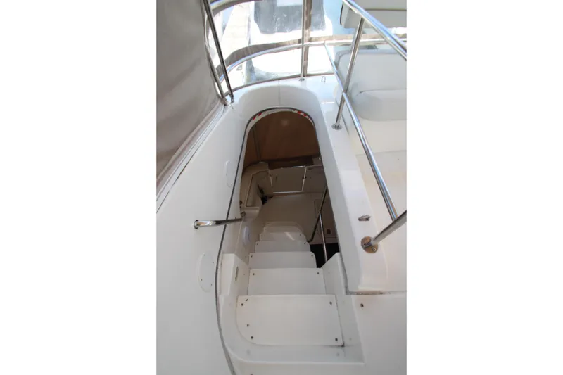 Slide: The Image of Staircase on 2006 Silverton 38 Sport Bridge yacht, featuring sleek white design and metal railings. - 50