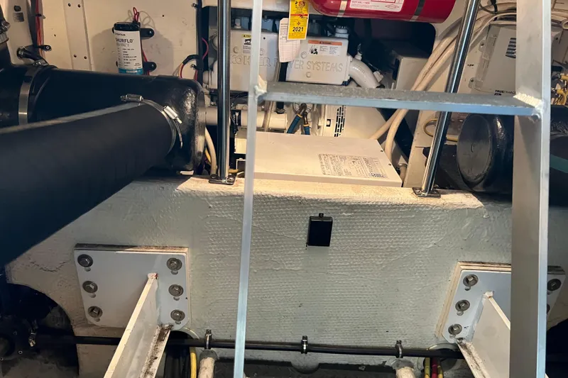 Slide: The Image of Engine room of a 2006 Silverton 38 Sport Bridge with visible machinery and components. - 52
