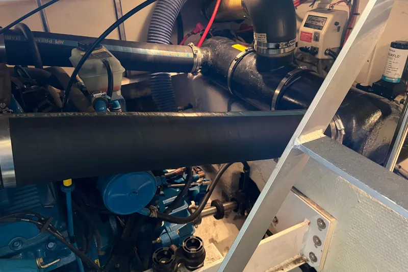 Slide: The Image of Engine compartment of a 2006 Silverton 38 Sport Bridge, showcasing mechanical components. - 54