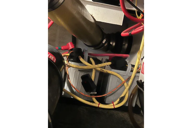 Slide: The Image of Engine compartment of a 2006 Silverton 38 Sport Bridge with visible wiring and components. - 56