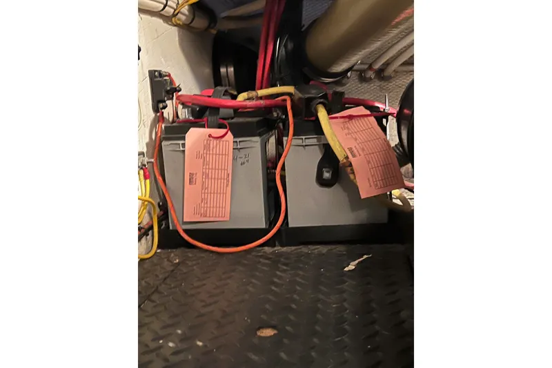 Slide: The Image of Battery compartment of a 2006 Silverton 38 Sport Bridge with labeled cables. - 57