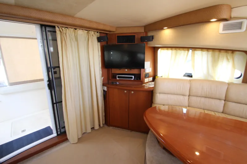 Slide: The Image of Interior of 2006 Silverton 38 Sport Bridge yacht with TV, seating, and dining area. - 6