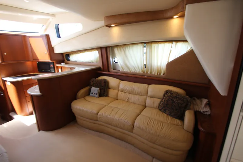 Slide: The Image of Interior of 2006 Silverton 38 Sport Bridge yacht with beige sofa and kitchenette. - 7