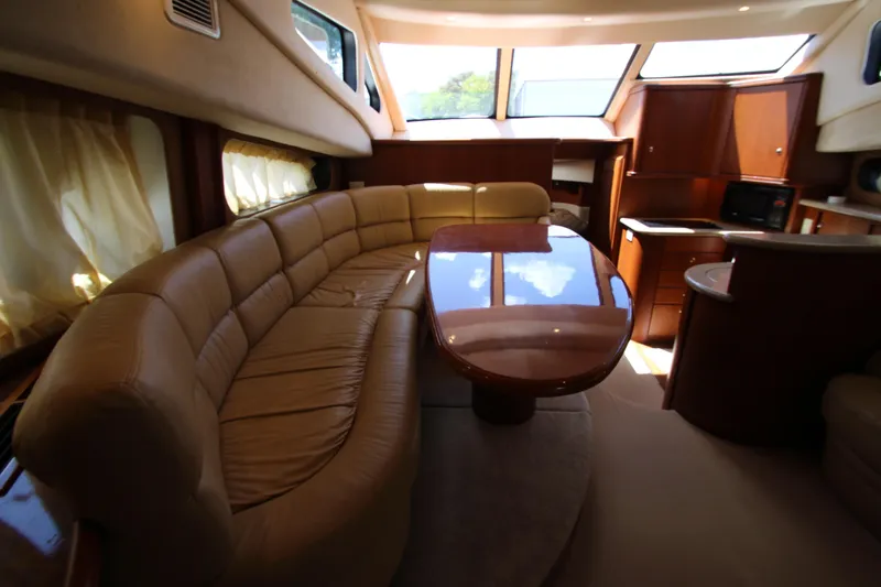 Slide: The Image of Luxurious interior of 2006 Silverton 38 Sport Bridge yacht with plush seating and elegant wood finishes. - 9