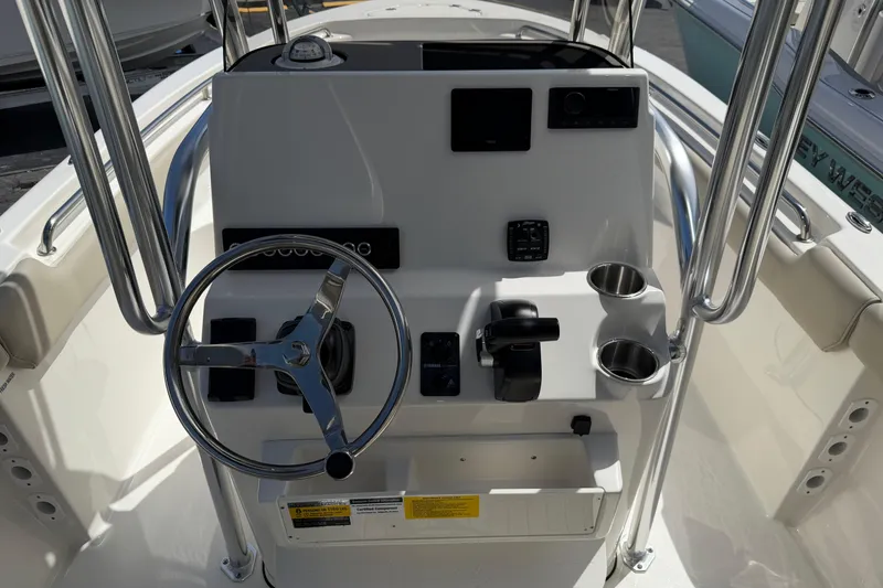 Slide: The Image of Steering console of 2026 Key West 203 FS boat with controls and cup holders. - 22