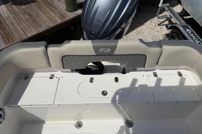 Slide: The Image of 2026 Key West 203 FS boat interior with cushioned seating and storage compartments. - 11