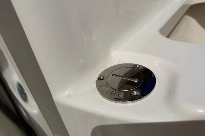 Slide: The Image of Key West 203 FS 2026 boat waste compartment with chrome cover. - 35