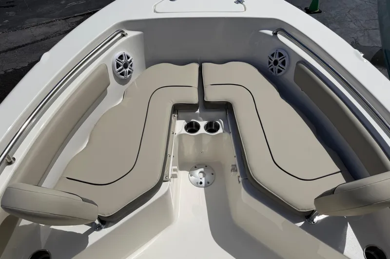Slide: The Image of 2026 Key West 203 FS boat interior with beige seating and cup holders. - 16