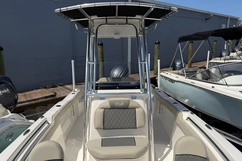 Slide: The Image of 2026 Key West 203 FS boat with sleek design and comfortable seating at a marina. - 13