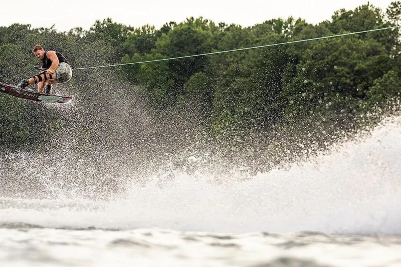 Slide: The Image of Wakeboarder performing a jump behind a 2018 Heyday WT-2 boat on a lake. - 28
