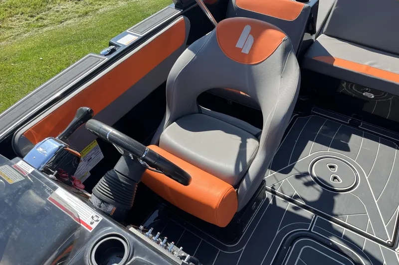 Slide: The Image of 2018 Heyday WT-2 boat interior with orange and gray seating, steering wheel, and dashboard controls. - 11