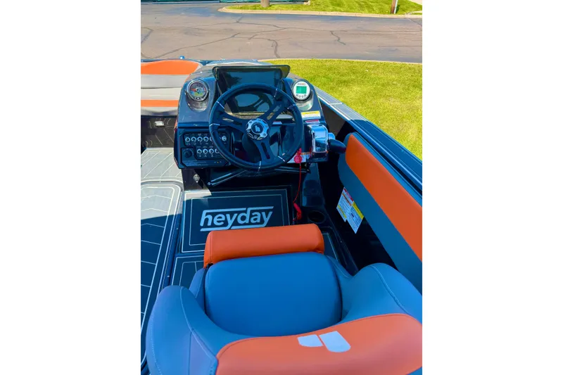 Slide: The Image of 2018 Heyday WT-2 boat interior with steering wheel and orange-gray seating. - 7