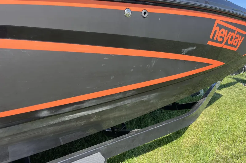 Slide: The Image of 2018 Heyday WT-2 boat with black and orange design on a grassy surface. - 26