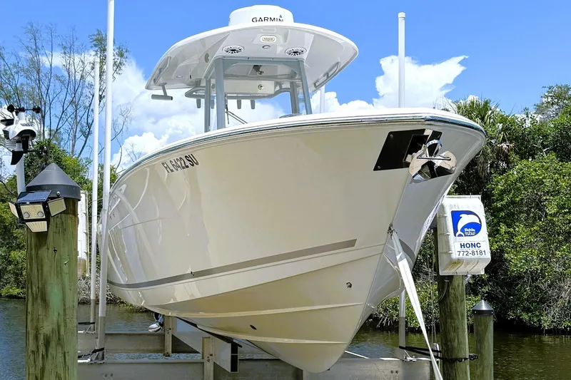 The Image of 2021 Cobia 280 Center Console boat docked, featuring sleek design and Garmin equipment. - 1
