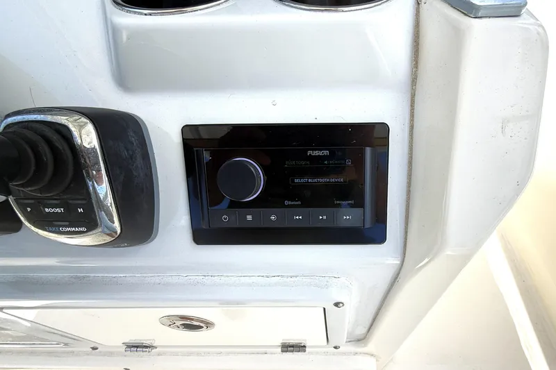 Slide: The Image of Control panel of a 2021 Cobia 280 Center Console boat with Fusion audio system. - 13