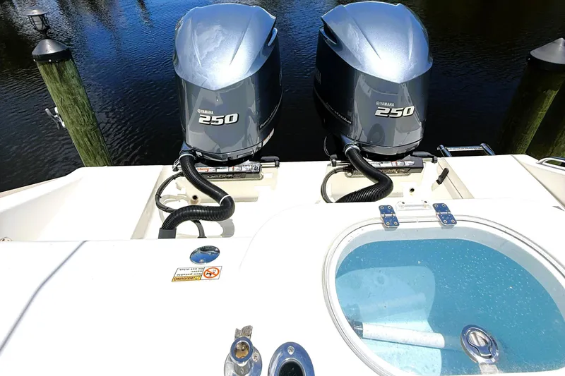 Slide: The Image of 2021 Cobia 280 Center Console with twin Yamaha 250 engines, docked by the water. - 14