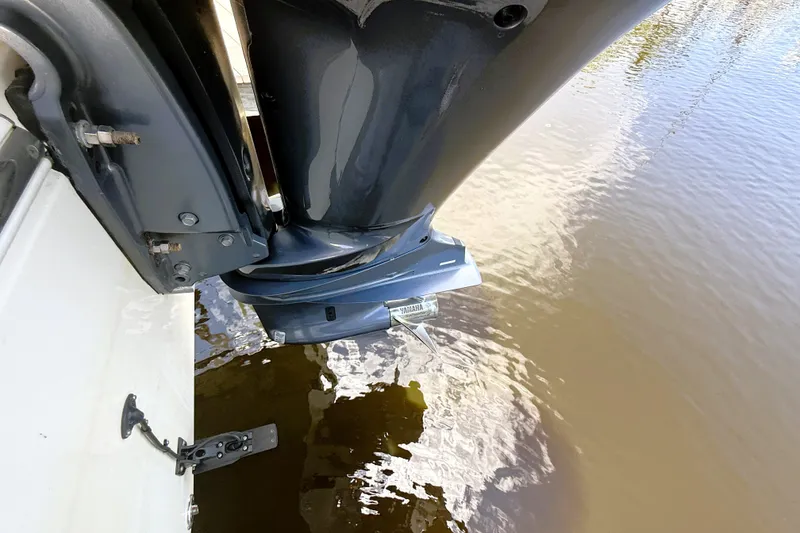Slide: The Image of Outboard motor of 2021 Cobia 280 Center Console boat on water. - 15