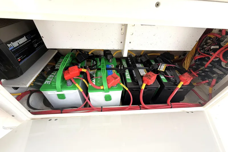 Slide: The Image of Battery compartment of 2021 Cobia 280 Center Console with Interstate batteries and wiring. - 16