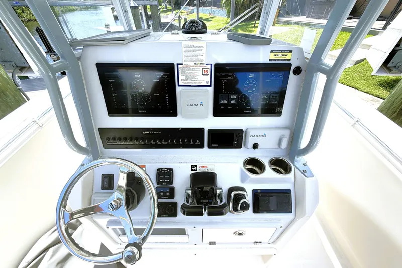 Slide: The Image of 2021 Cobia 280 Center Console helm with Garmin displays and steering wheel. - 4