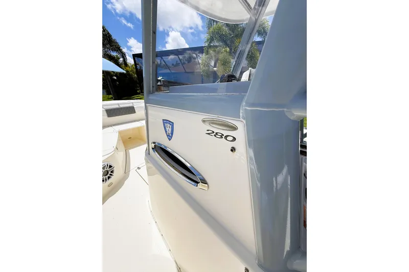 Slide: The Image of 2021 Cobia 280 Center Console boat, close-up of helm area under sunny sky. - 6