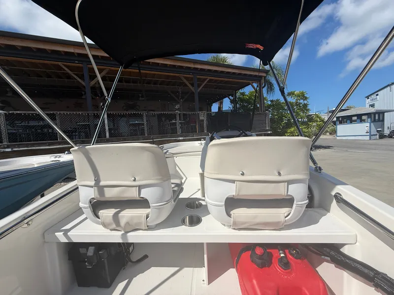 Slide: The Image of The image shows the cockpit of a 2027 Boston Whaler 130 Super Sport with two white seats. - 12