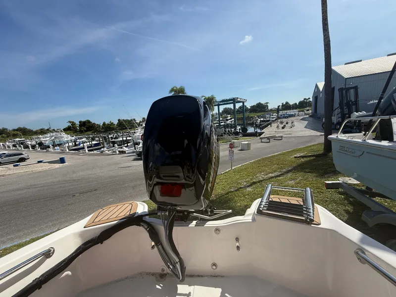 Slide: The Image of The image shows the stern of a Boston Whaler 130 Super Sport with an outboard motor. - 15