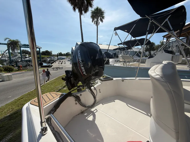 Slide: The Image of The image shows a Boston Whaler 130 Super Sport boat with a Mercury outboard motor. - 14