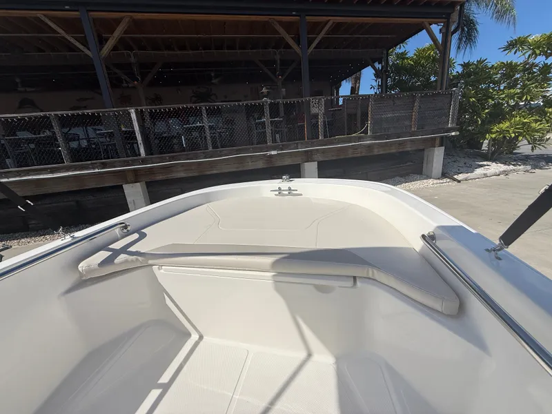 Slide: The Image of The image shows the bow of a 2027 Boston Whaler 130 Super Sport with a seating area. - 5