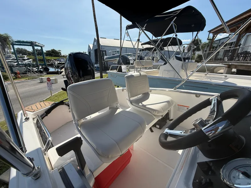 Slide: The Image of The image shows the cockpit of a 2027 Boston Whaler 130 Super Sport with white seats and a black steering wheel. - 9
