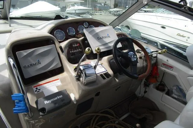 Slide: The Image of 2006 Sea Ray Sundancer 320 helm with Garmin and Raymarine navigation systems. - 9