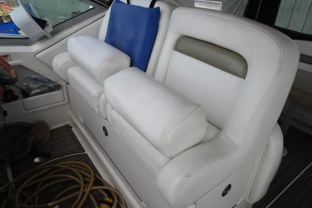 Slide: The Image of 2006 Sea Ray Sundancer 320 interior with white leather seating and blue cushion. - 8