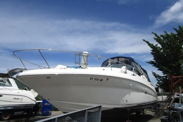 The Image of 2006 Sea Ray Sundancer 320 yacht docked under a clear blue sky. - 1