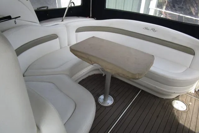 Slide: The Image of Interior of 2006 Sea Ray Sundancer 320 with white seating and wooden table. - 6