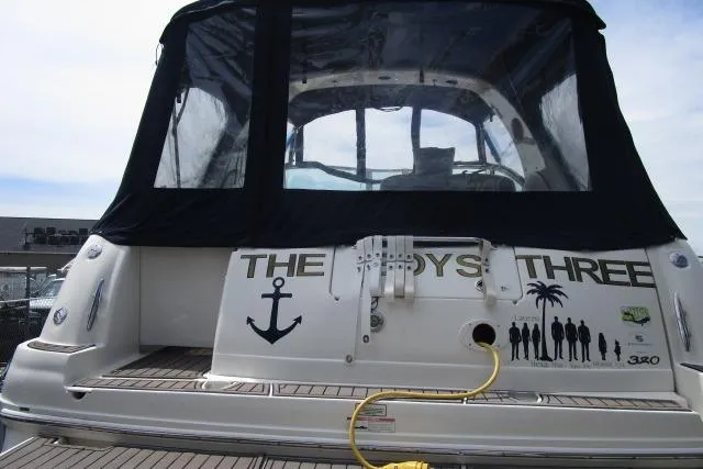 Slide: The Image of 2006 Sea Ray Sundancer 320 yacht with custom graphics and black canopy. - 3