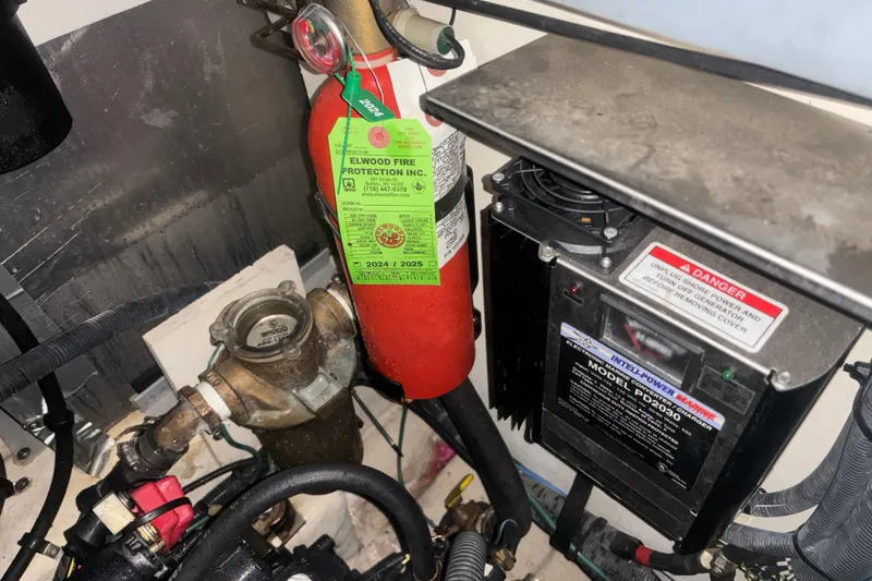 Slide: The Image of Engine room of 2006 Sea Ray Sundancer 320 with fire extinguisher and electrical components. - 20